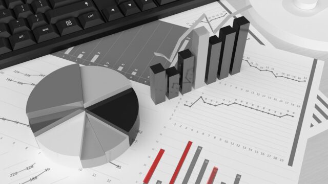 Des barres, des courbes et un graphique en secteur, avec un clavier en arrière-plan, llustration des concepts d'inbound et outbound marketing